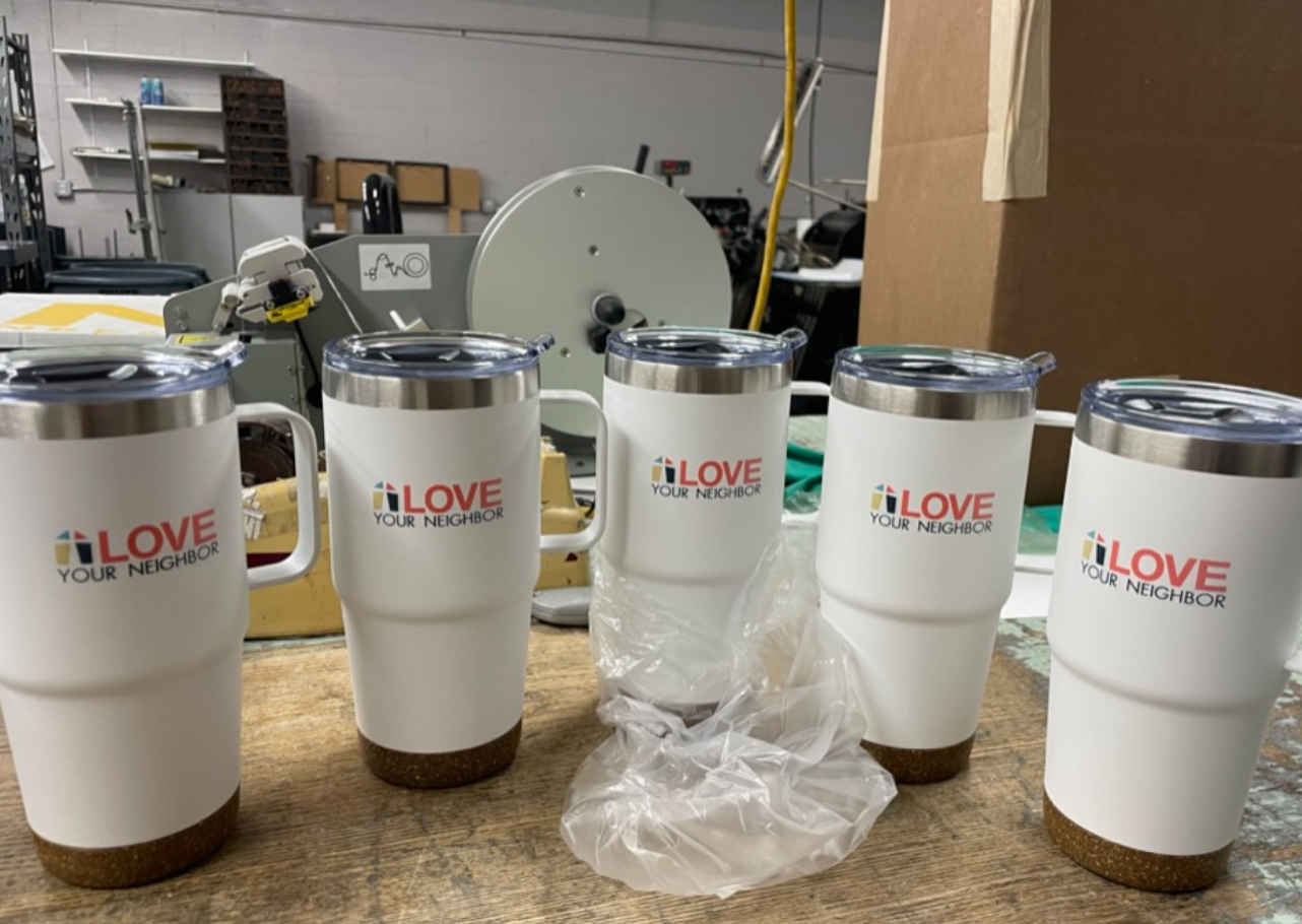 Promotional branded tumblers printed for Love Your Neighbor campaign at Schreur Printing in Holland MI