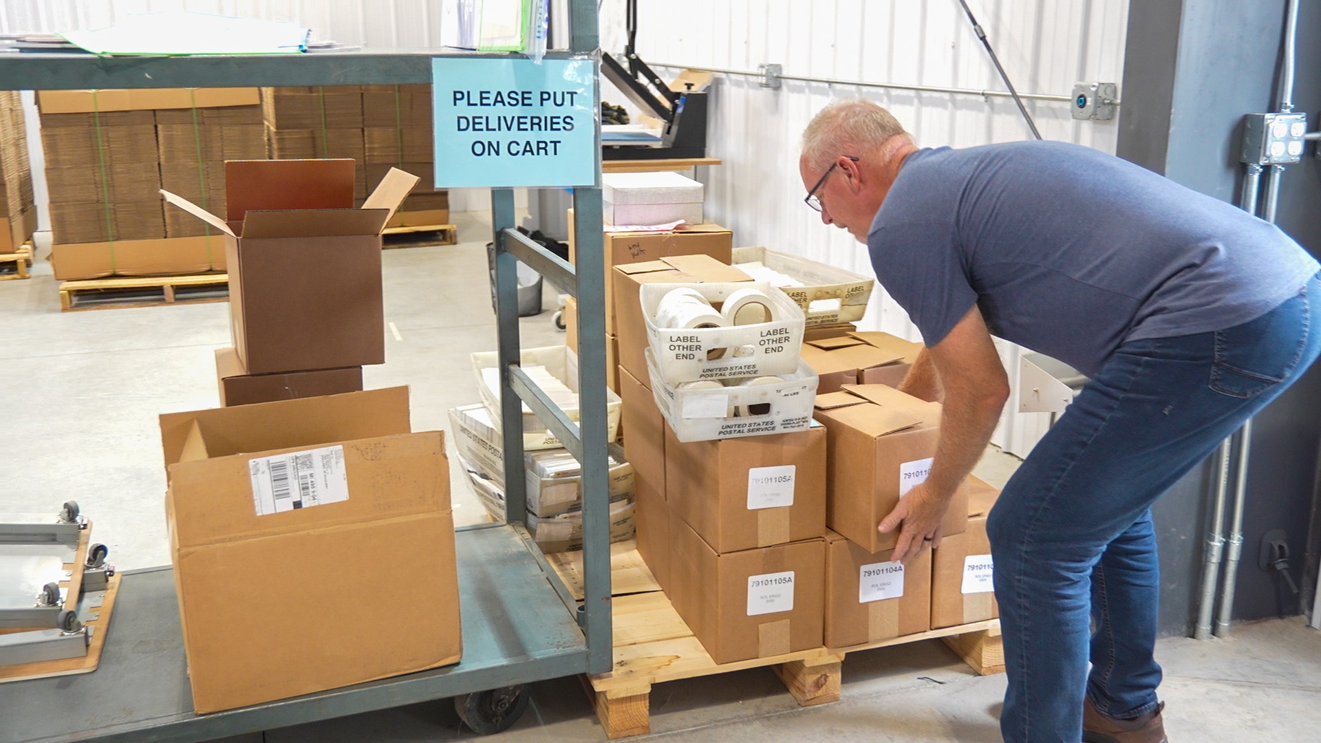 Mailing and direct mail service delivery preparation by employee at Holland MI print shop