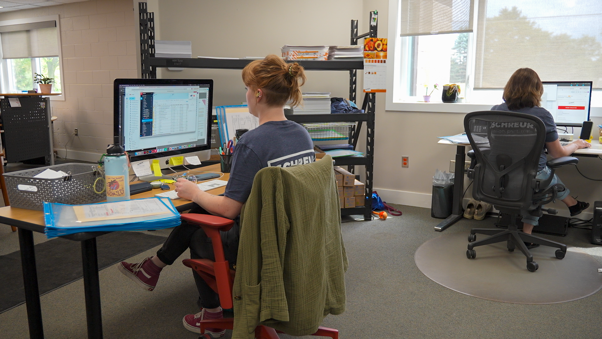 Employees reviewing files online for custom printing services at Schreur Printing in Holland Michigan