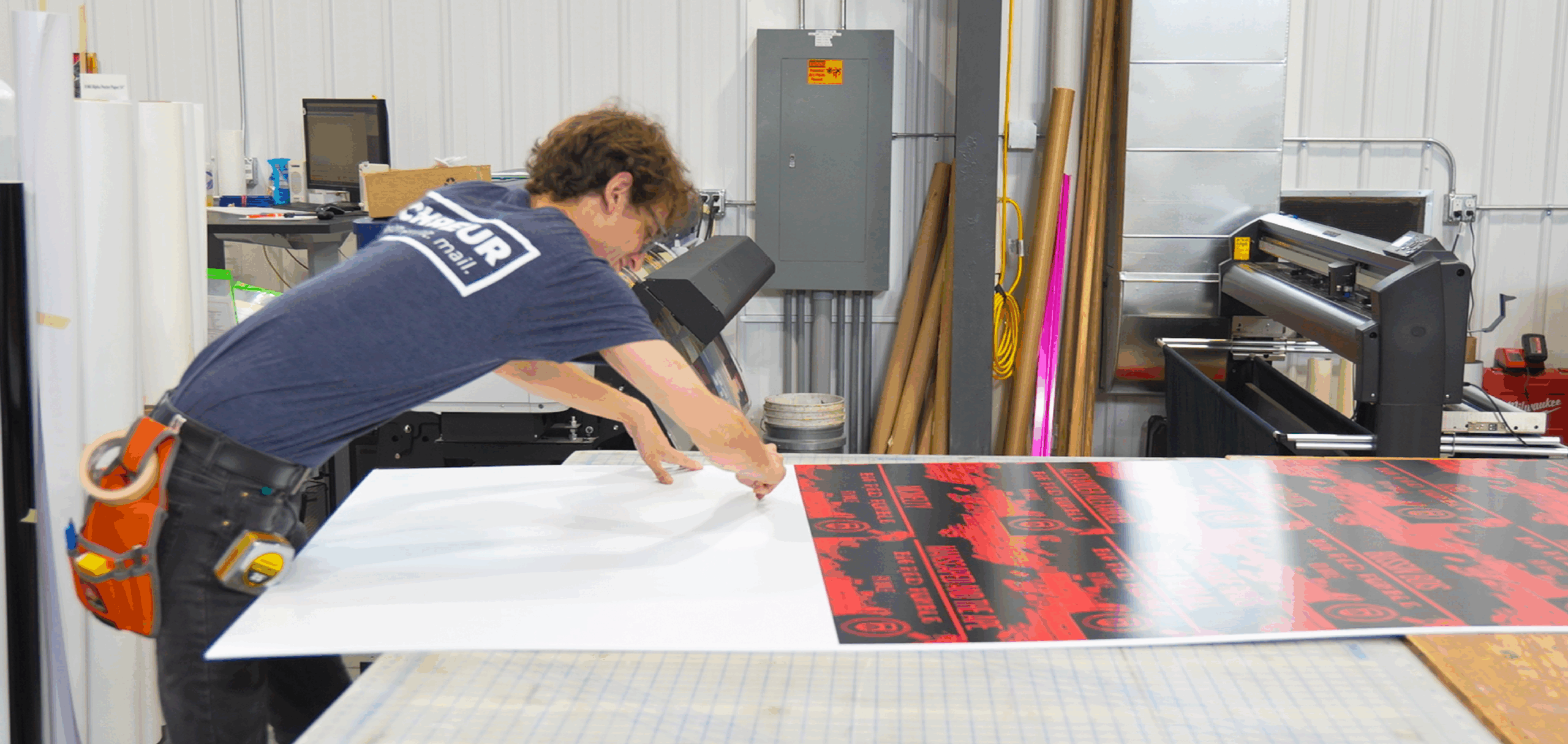 Schreur Printing staff preparing custom banner for commercial printing in Holland Michigan