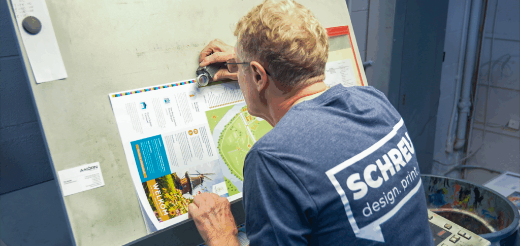 Holland Michigan Schreur Printing employee inspecting commercial print job