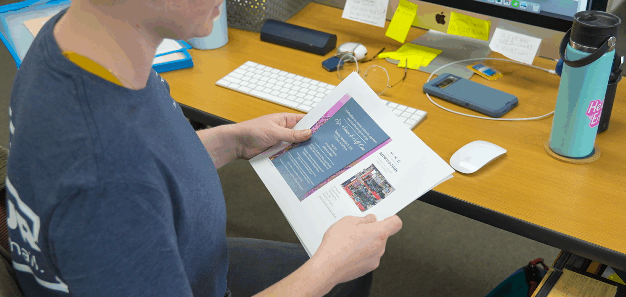 Schreur Printing employee reviewing printed invitation design